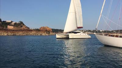 Fontaine Pajot Athena 38 catamaran sailing into Beauport Bay Jersey on skippered private charter