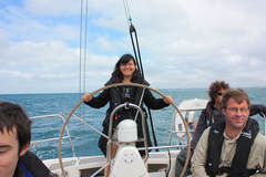 at the wheel of a Dufour 34 Performance on a RYA Coastal Skipper course