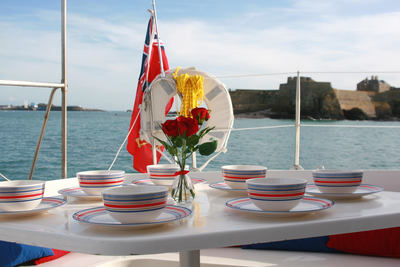 Table set for buffet aboard sailing catamaran in Jersey