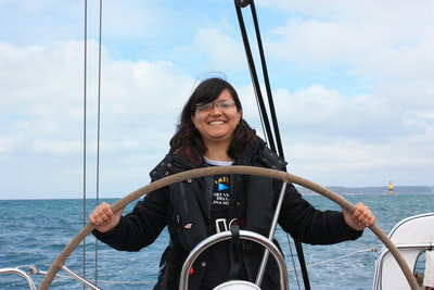Girl helming Dufour 34 Performance on a Sailing Skills course
