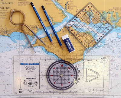 Charts, portland plotter, dividers used on RYA Competent Crew course